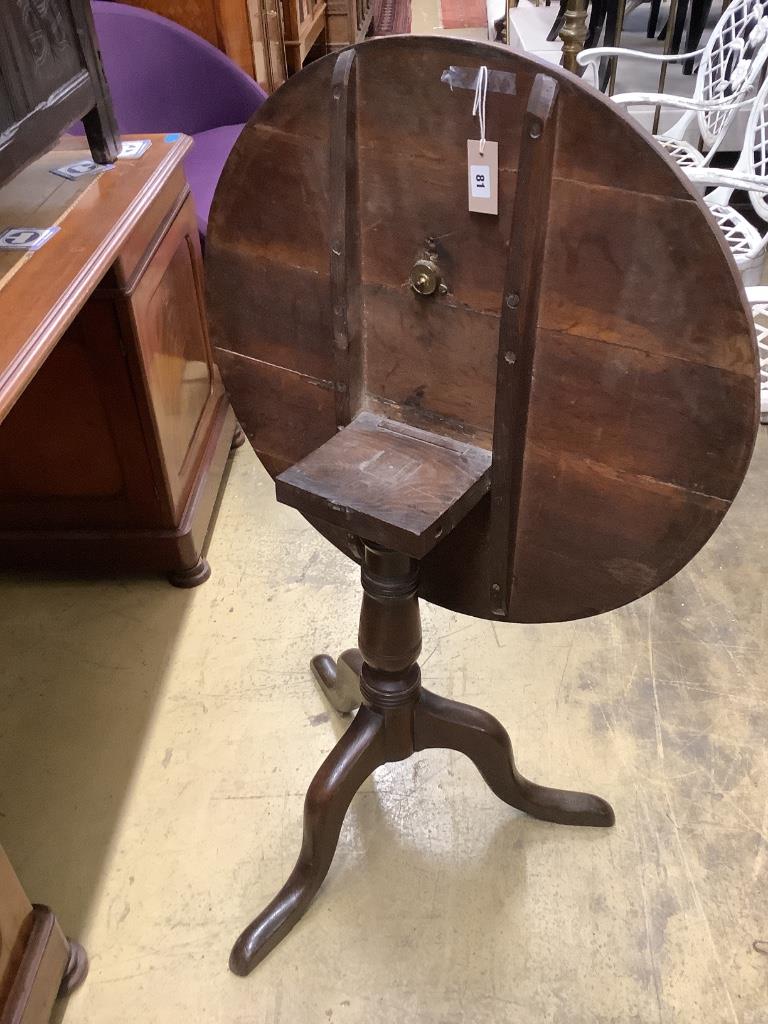 A George III oak circular tilt top tea table, diameter 75cm height 70cm